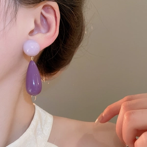 Detail of elegant purple acrylic water drop earrings worn showing product size and gloss