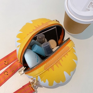Top view of sunflower crossbody bag opening to show interior capacity with cosmetics