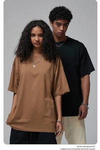 Detail of loose oversized crewneck cotton t-shirts in brown and black color options