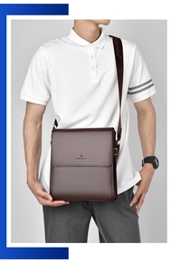 Detail of dark brown leather messenger bag with flap cover and printed shoulder strap