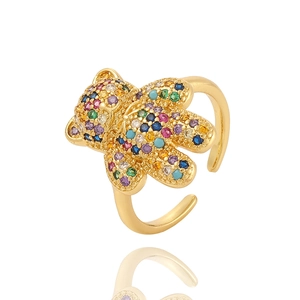 Charming golden bear ring with sparkling colorful zircon inlay on a white background