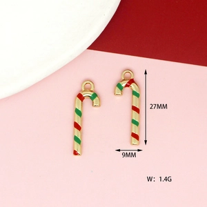 Detailed view of candy cane charm in red and green enamel for DIY jewelry making