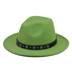 Detail of green wool fedora hat featuring a black band with turquoise beads and silver studs