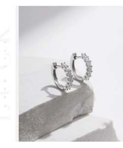 Detailed view of S925 sterling silver hoop earrings with sparkling moissanite stones