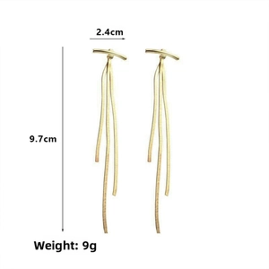 Detail of long gold tassel earrings showing dimensions 2.4cm width and 9.7cm length