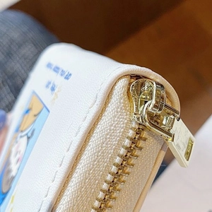 White leather credit card holder with cute cartoon print and gold zipper detail