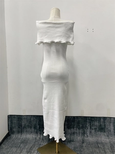 Back view of a white off-shoulder knitted dress with elegant ruffle trim details