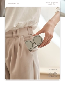 Foldable neck fan being placed into a pocket to show its ultra-portable compact size