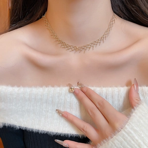 Close-up of golden mesh fringe choker necklace on neck showing intricate woven texture