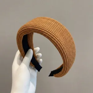 Detail of ginger yellow knitted headband with thick sponge padding and non-slip inner lining
