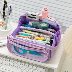 Close-up of a purple multi-layer large capacity canvas pencil case with stationery items