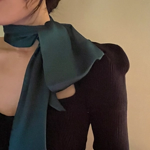 French vintage dark green silk scarf tied in a bow with black knitwear top