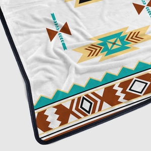Soft flannel blanket with bohemian geometric pattern and turquoise color accents