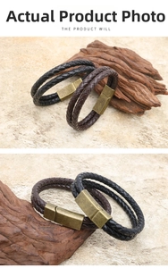 Close-up of black and brown braided leather bracelets with vintage magnetic bronze clasps