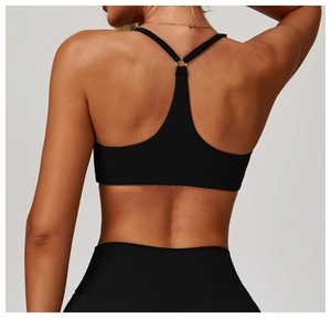 Detail of black sports bra featuring a racerback design with metal ring connector