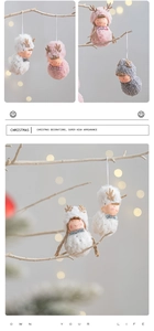 Christmas plush doll hanging decorations in pink, white, and gray on wooden branches