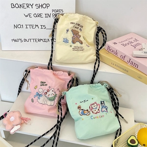 Three colorful canvas bucket bags with cute bear and cat embroidery on display