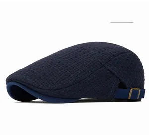 Detail of navy knit ivy cap fabric texture with antique bronze metal buckle