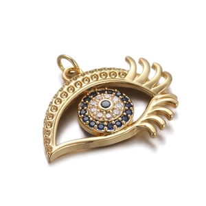 Detailed view of a gold Evil Eye pendant with blue and clear zircon crystals