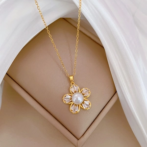Detailed close-up of a gold titanium necklace with a pearl and zircon flower pendant