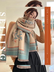 Detail of warm cashmere-like shawl with vintage floral patterns and fringe edges