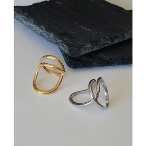 Minimalist double-layer irregular twisted rings in gold and silver on slate