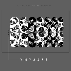 Detail of black and white nail wraps with tropical leaf designs and 14 pieces per set