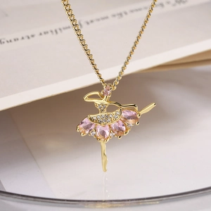 Golden ballerina pendant necklace with pink gemstone and zircon on braided chain