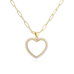 Elegant gold plated heart pendant necklace with zircon crystals on white background