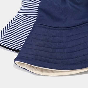 Detailed texture of breathable mesh and striped fabric on wide brim sun protection hats