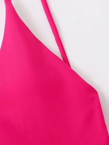 Detail of rose red elastic bikini fabric with thin shoulder strap and fine texture