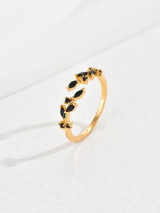 Detailed view of adjustable gold leaf ring set with sparkling black marquise zircons