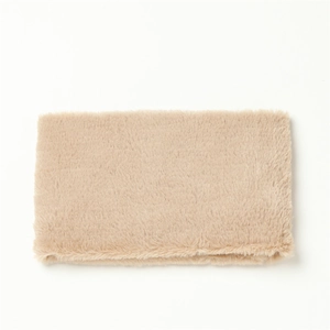 Detail shot of the beige faux rabbit fur scarf showing its soft plush texture and material