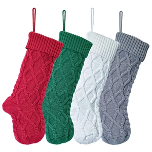 Detailed view of four colorful knitted Christmas stockings with diamond cable patterns