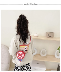 Detailed back view of a child wearing a lollipop-shaped red and white crossbody purse