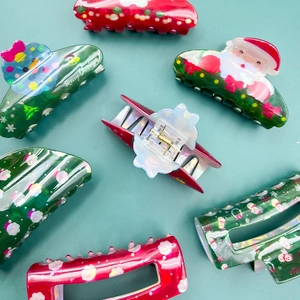 Medium PVC Christmas hair claws with festive laser print patterns and Santa Claus designs