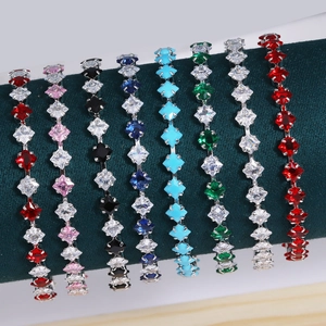 Glittering square zircon tennis bracelets in multiple colors on a green velvet display