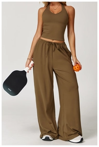 Detail of olive green ribbed workout set featuring a halter crop top and wide-leg joggers