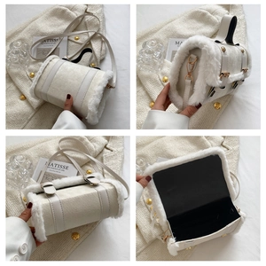 Detail view of white plush cylinder handbag with gold hardware and interior layout