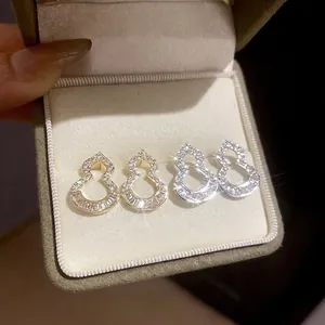 Hollow wulu stud earrings with cubic zirconia and sparkling diamonds in silver and gold