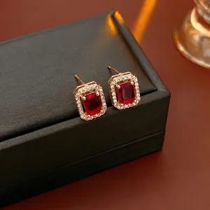 Elegant 18K gold-plated rectangular ruby stud earrings with halo of sparkling zirconia
