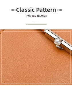 Detail of orange lychee leather crossbody bag with silver metal clasp and pearl accent