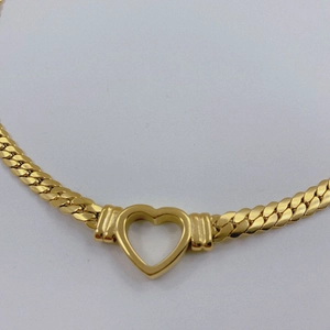 Chunky gold titanium steel necklace featuring a large polished hollow heart pendant