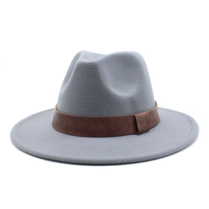Detail of grey wool fedora hat featuring a brown leather decorative band and flat brim
