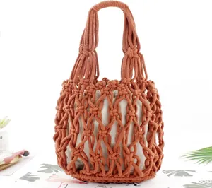 Detail of handmade red cotton rope woven beach bag with beige inner drawstring pouch