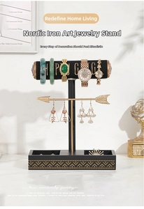 Close-up of a black velvet watch cylinder and golden jewelry stand with marble base tray