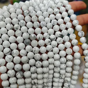 Detailed macro view of natural white turquoise beads with grey webbed marble patterns