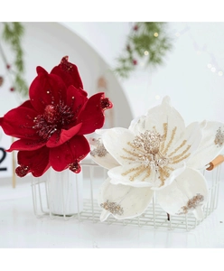Close-up of red and white velvet magnolia flowers with sequins in a white metal basket