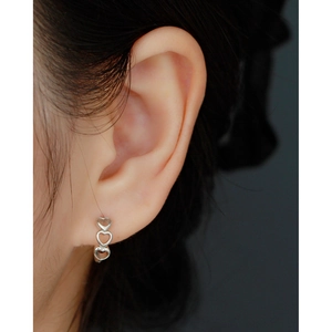 Detail showing high-quality s925 silver triple heart hoop earring worn on a model's ear