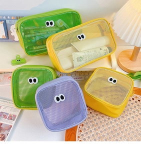 Detail of mesh storage bags with cute eye patches in green, yellow and purple